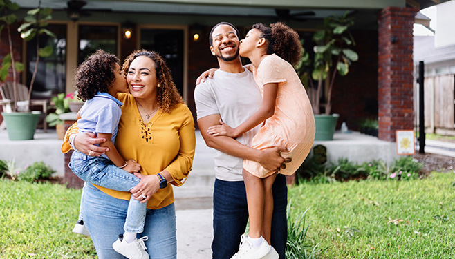 family standing outside of home