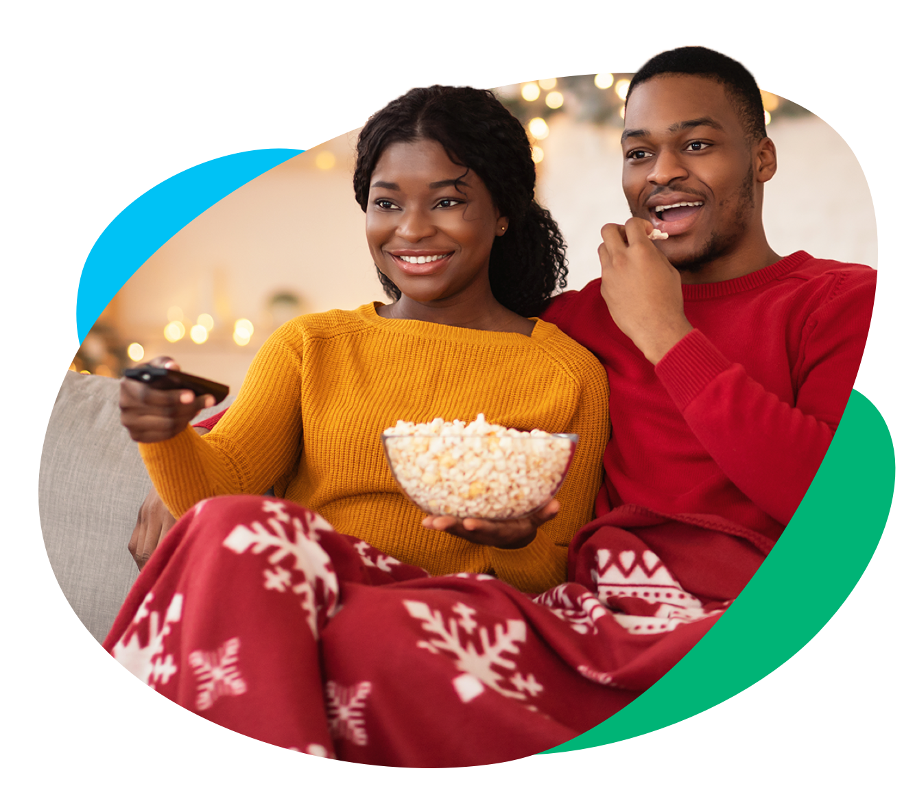 Man and woman eating popcorn and watching TV