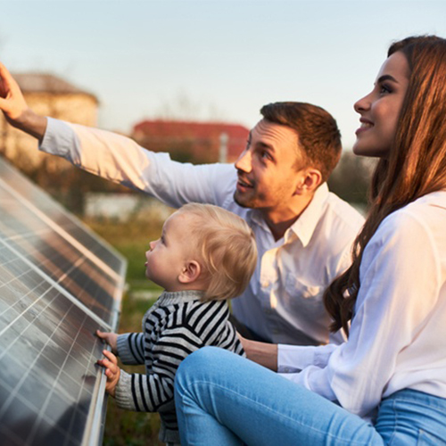 family looking at solar panels