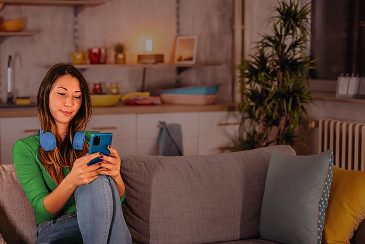 Woman on her phone with headphones