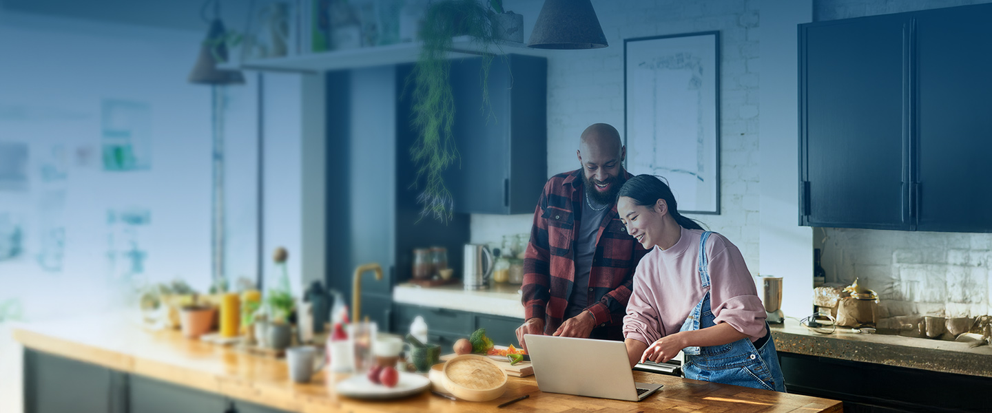 Couple in kitchen cooking
