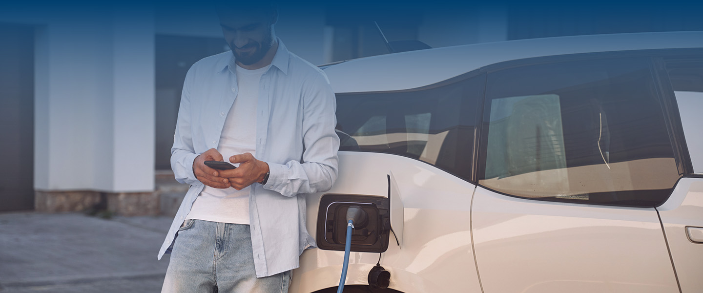 man charging electric vehicle