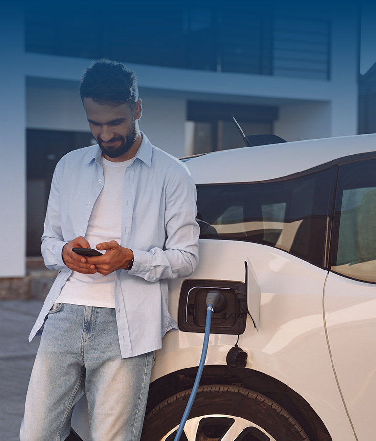 man charging electric vehicle