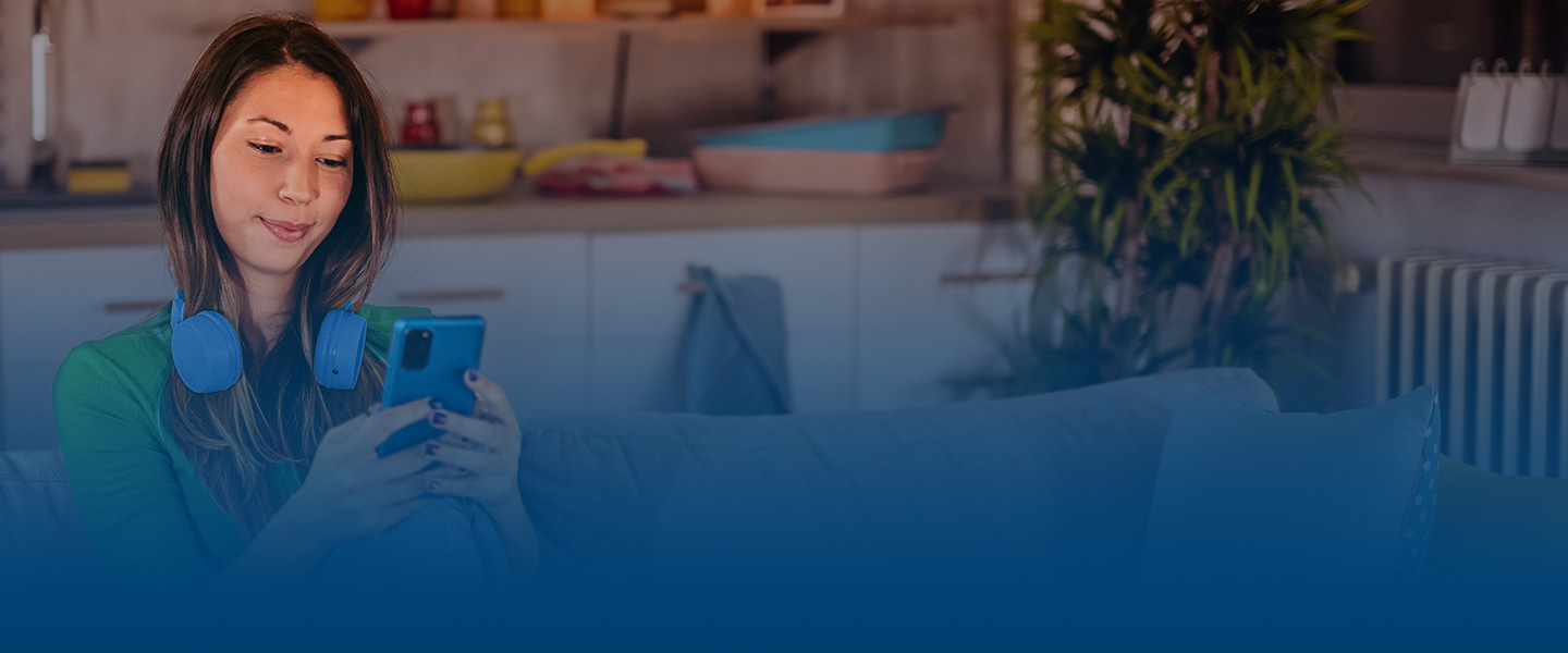 woman sitting down looking at phone