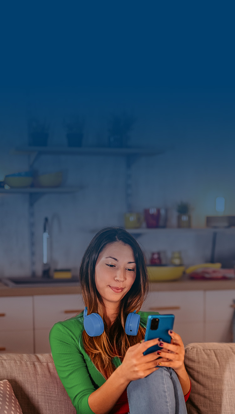 woman sitting down looking at phone