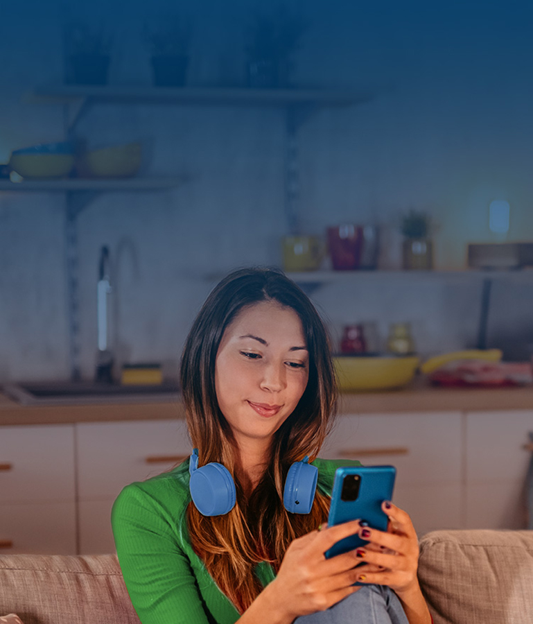 woman sitting down looking at phone