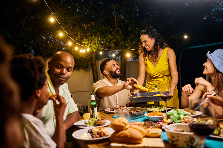 people sitting outside eating dinner